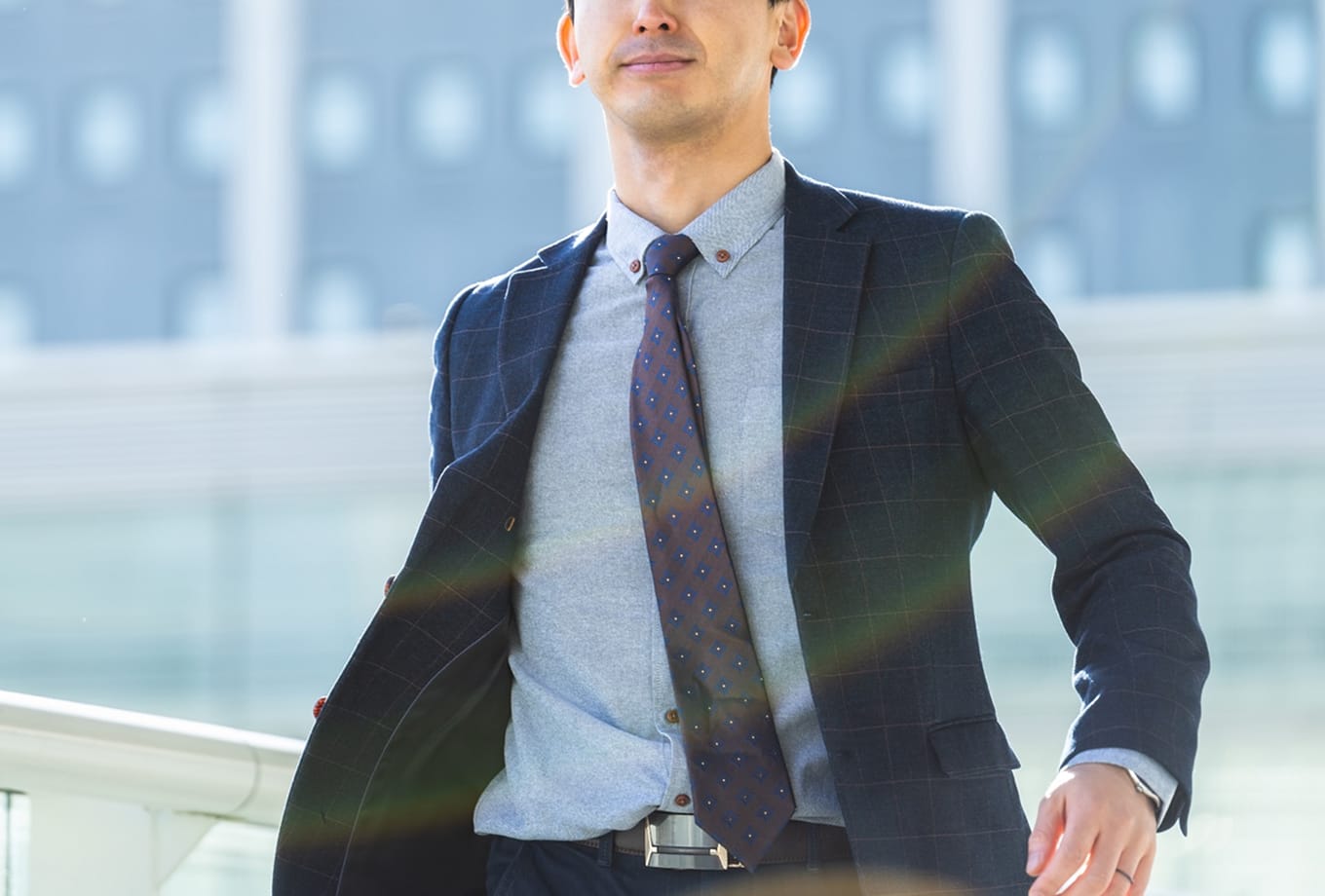 スーツ姿でネクタイを整える男性